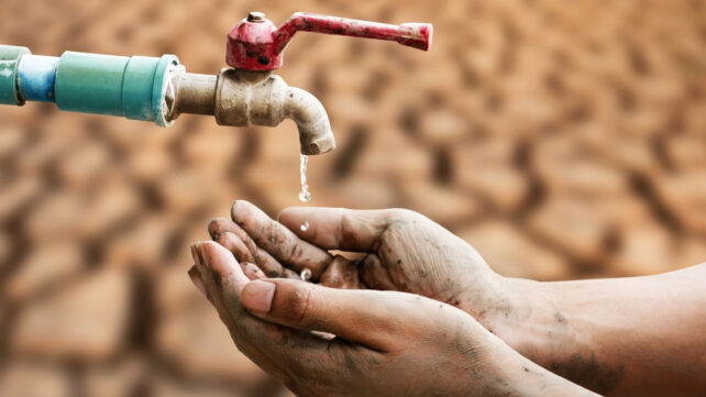 hands under a dripping tap