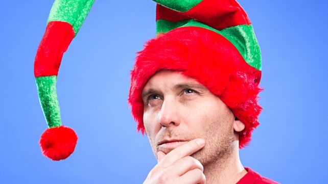 Man wearing a green and red elf-style hat