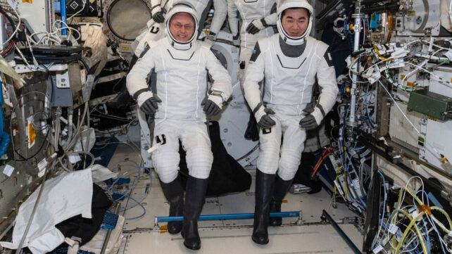 Astronauts inside a module on the ISS