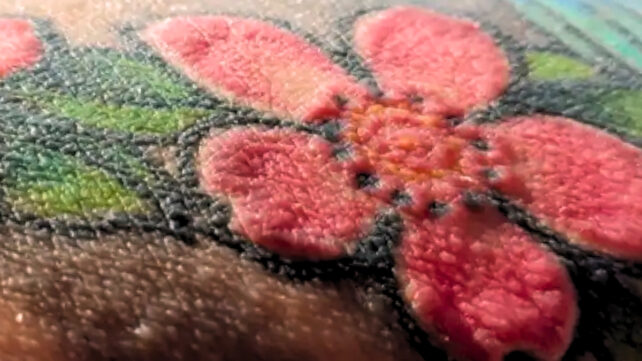 red tattooed flower