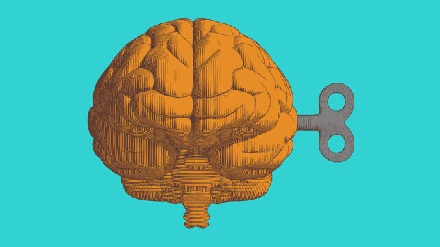 Colorful orange vintage engraving drawing human brain with wind up key