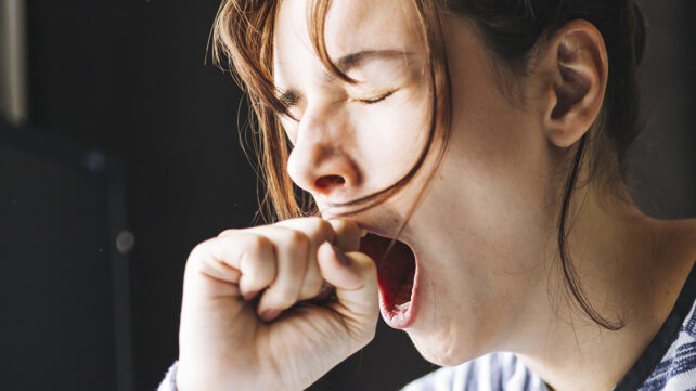 A young man yawning